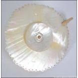 A 19th century mother of pearl shell chamberstick candle.