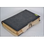 A Victorian leather embossed photograph album containing many black and white photograph studies of