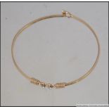 A 9ct gold and diamond ladies bangle / bracelet being hallmarked for London 1978.
