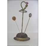 A late 19th / early 20th century silver plate hat pin stand in the form of a thistle with a