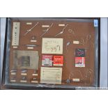 A framed and mounted montage of fishing items to include hooks, weights, Hardy's label etc.