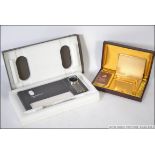 A retro Win international cased cigarette case and lighter together with a cased 1980's retro desk
