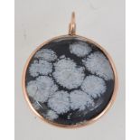 A hallmarked Edwardian 9ct gold pendant with inset large snowflake obsidian cabouchon .