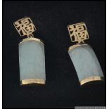 A pair of jade and 9ct gold drop earrings the earrings of oblong form with sleeper clasp fittings