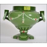 An early 20th century Austrian Eichwald secessionist twin handled vase having green glaze with