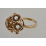 A 9ct gold Art Deco dress ring with central round cut citrine surrounded by scalloped set pearls in