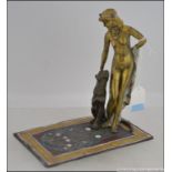 A 20th century Art Deco Austrian cold painted bronze figure of a female figure with a seated puma