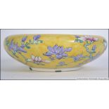 A 19th century Chinese famille Juane dish with decorative birds of paradise design on yellow ground