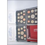 A collection of 3 United Kingdom proof coin sets 1999 x 2 and a 2001 de-lux proof set all with