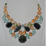 A large ladies contemporary silver and multi gem stone necklace choker.