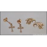 A pair of 375 - 9ct gold earrings in the form of crosses / crucifx together with a pair of 9ct