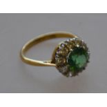 A marked 18ct and platinum green stoned ladies dress ring with diamond surround 4.
