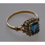 A hallmarked 9ct gold ladies dress ring with a large central blue stone and diamond surround 3.