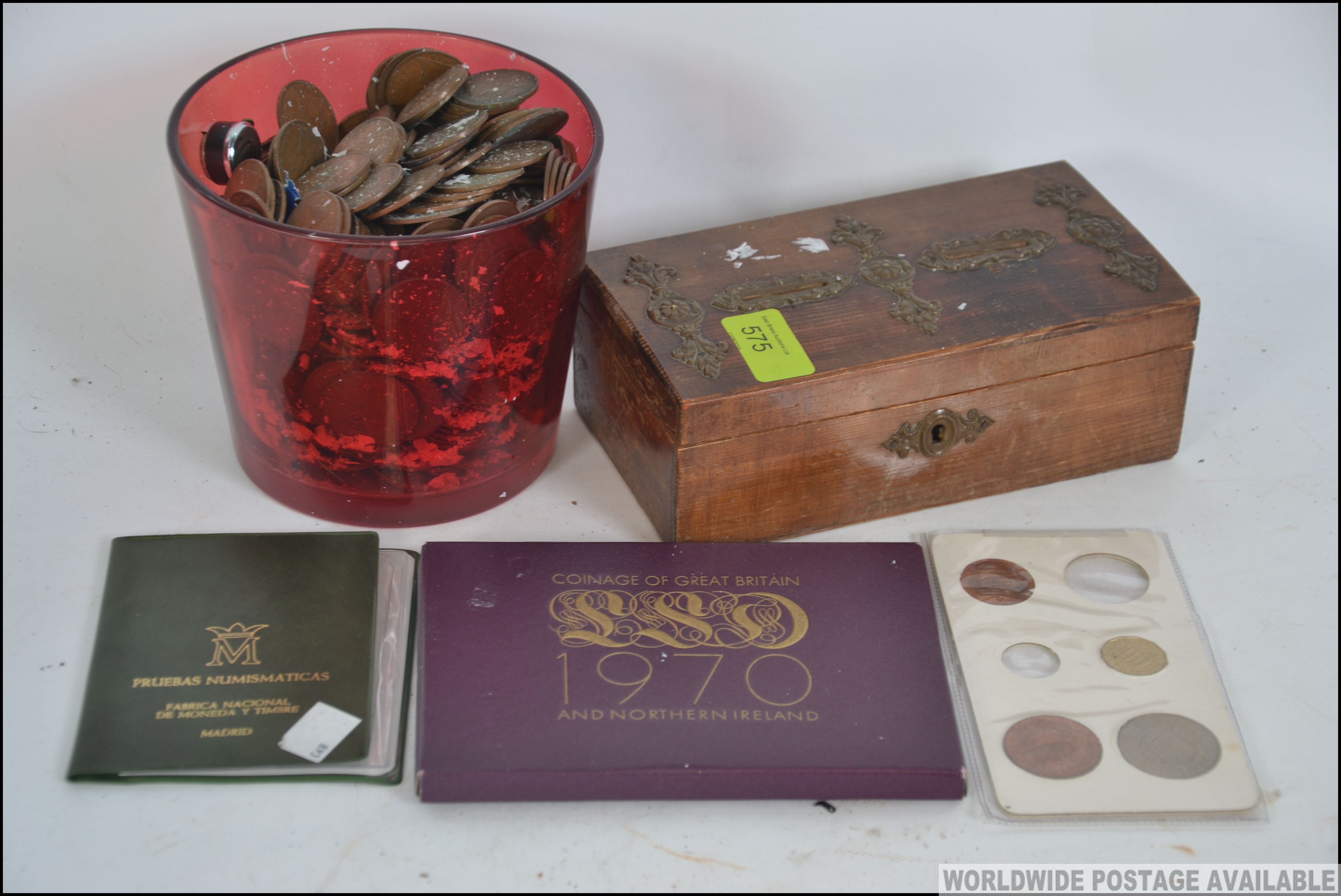A collection of vintage British coins dating from the 19th century along with a vintage wooden