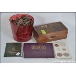 A collection of vintage British coins dating from the 19th century along with a vintage wooden