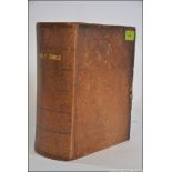 A large Holy Bible being leather bound - Old and New Testaments by The Reverend Matthew Hendy -