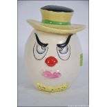A retro / vintage ceramic swear / mood box in the form of a scowling clown,
