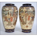 A pair of early 20th century Japanese hand painted Kutani vases with a blue ground having central