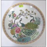 A 20th cenutry Chinese famille rose charger with yellow geometric borders having handpainted