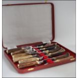 A stunning set of cased horn handled steak knives and forks by F & H limited in the original