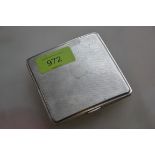 A silver hallmarked cigarette case having an engine turned geometric pattern,