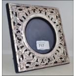 A silver hallmarked fret pierced easel picture frame having a blue velvet backing London assay