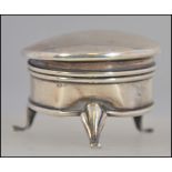 A hallmarked silver antique powder / snuff pot. Standing on three legs, with hinged top.