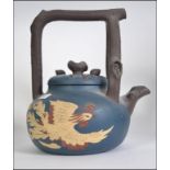 A Large Chinese Terracotta Kettle, a blue ground with a dragon raised to one side,