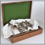 An Edwardian oak canteen of cutlery being baize lined together with loose cutlery believed to be