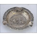 A continental silver hallmarked pin dish ashtray cast in relief with central diorama of tavern