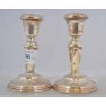 A pair of matching filled silver hallmarked stump candle sticks with Birmingham assay marks 245.