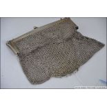 A large silver white metal ladies mesh purse with finial clasp and chain handle,