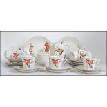 An art deco style be China tea service having hand painted floral designs and consisting of cups,