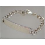 A silver hallmarked identity bracelet having a curb link chain along with a silver rope twist