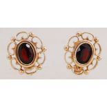 A pair of 9ct gold earrings set with gar