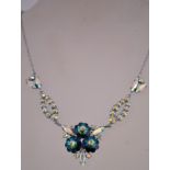 A 1980s rhinestone necklace in a silver tone metal setting with aroura rhinestones and flower