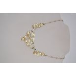 A 1970s jewelcraft necklace in gold tone metal with faux pearls and a hook clasp,