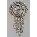 A large 1950s to 1960s fringe brooch in silver tone metal with a roll over catch,