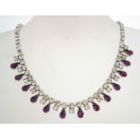 A 1950s rhinestone necklace in a silver tone metal setting with a fold over catch,