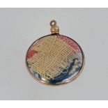 A WW1 photo pendant, containing small pieces of a union jack flag.