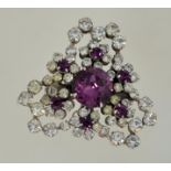 A 1950s to 1960s rhinestone brooch in a silver tone metal setting with a roll over catch,