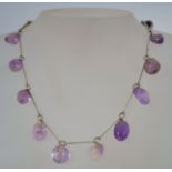 A 1960s silver tone metal and amethyst necklace with a loop clasp, measuring 41.5cms long.