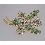 A 1950s rhinestone spray brooch with aurora and peridot colour rhinestones in a gold tone metal