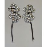 A pair of art deco hair grips, in silver tone metal with rhinestones, measuring 6cms long.