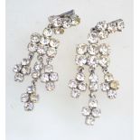 A pair of 1950s to 1960s rhinestone chandelier clip earrings in a silver tone metal setting,