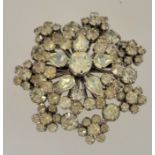 A 1950s to 1960s rhinestone cluster brooch in a silver tone setting with a rollover clasp,