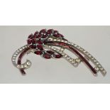 A large 1950s rhinestone brooch in a silver tone setting with a rollover clasp, measuring 7cms long.