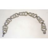 A 1930s art deco rhinestone bracelet, in silver tone metal with a box clasp, measuring 18cms long.