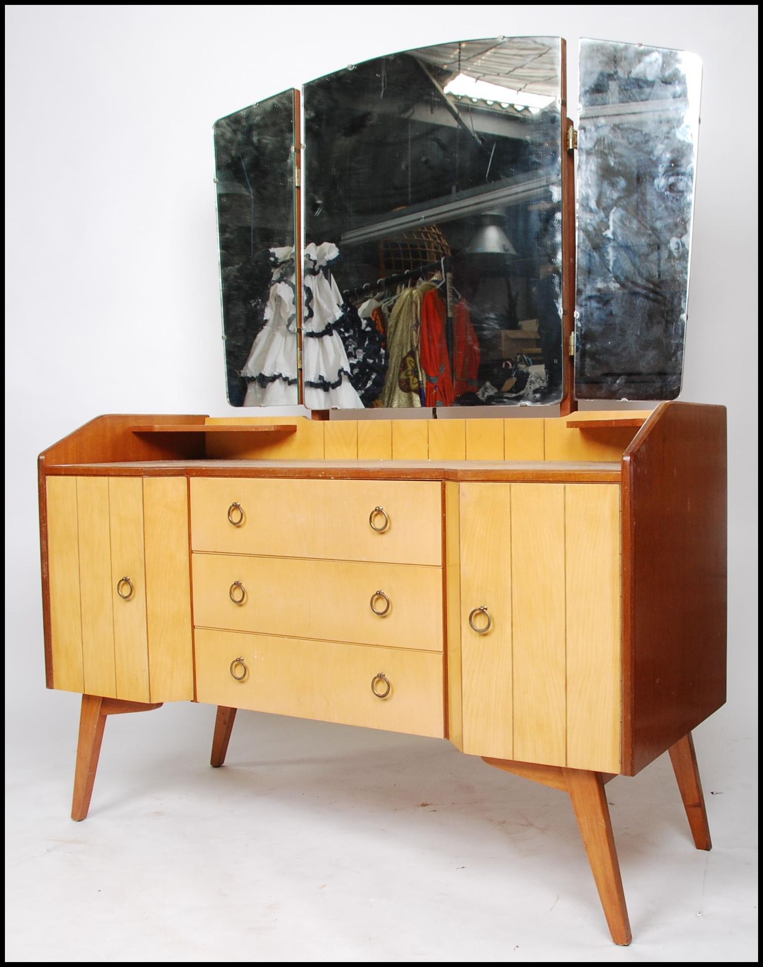 A pair of 1950's retro oak and maple wood dressing table raised on square tapered legs with drawers