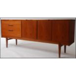 A 1970's Nathan teak sideboard dresser raised on tapered legs with a series of drawers and cupboard